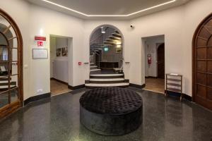 a hallway with a stairway with a large tire on the floor at Hotel Villa Alberti Portofino Land in Santa Margherita Ligure