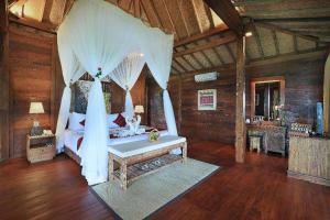 a bedroom with a bed with mosquito netting at Sunia Jungle Ubud View by EPS in Ubud +70 photos