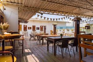 a restaurant with tables and chairs in a room at Casa Mara Dakar in Dakar