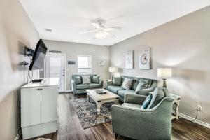 a living room with a couch and a tv at Chillin' Channelside in Padre Island