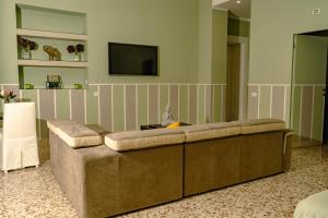 ein Wohnzimmer mit einem Sofa und einem TV in der Unterkunft MammaDada charm rooms in Bari