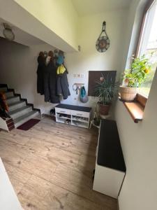 a living room with a staircase and hangers at Penzion u krbu in Loket