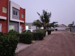 a car parked on a street next to a building at Spacious Luxury 3Bed Hse in Tema - Netflix Wi-fi in Dawhwenya