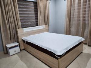 a bed in a room with a window with a mattress at Spacious Luxury 3Bed Hse in Tema - Netflix Wi-fi in Dawhwenya