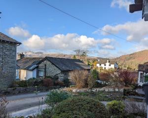 a village with houses and mountains in the background at Skelwith Fold Cottage No.3 in Elterwater