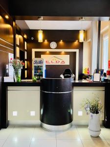 a fast food restaurant with a counter with flowers at Hotel Elda in Bydgoszcz