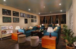 a living room with blue couches and tables at Five Gangtok in Gangtok