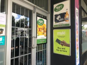 a building with signs on the door of a store at A single room near the railway station in Melbourne