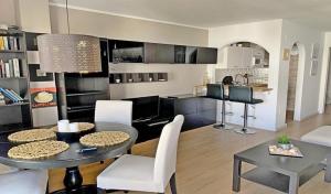 a kitchen and a living room with a table and chairs at Laguna Beach, Todos los Santos in Torrox Costa