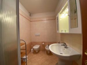 a bathroom with a sink and a toilet at Panoramic View Ledro Apartment in Mezzolago +36 photos