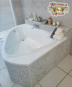 a large white bath tub in a bathroom at Uslugi Hotelowe Restauracja Rajska in Lubliniec +24 photos