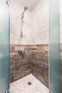 a bathroom with a shower with a glass door at Florance flat next to Old Town & City Center NEW in Plovdiv
