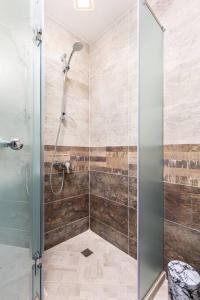 a shower with a glass door in a bathroom at Florance flat next to Old Town & City Center NEW in Plovdiv