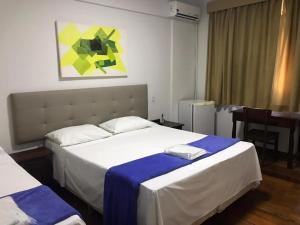 Ένα ή περισσότερα κρεβάτια σε δωμάτιο στο Ubaense Plaza Hotel +41 φωτογραφίες