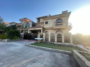 a large house with a driveway in front of it at Dream Palace in Islamabad