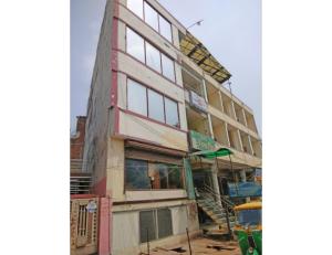 a building under construction with a bus in front of it at Viren Plaza, Agra in Agra