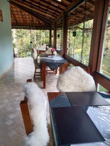 a living room with two white animals sitting on chairs at MD Luar da Montanha in Monte Verde