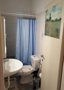 a bathroom with a white toilet and a sink at Mom's Cozy Corner in Heraklio