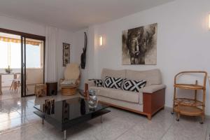 a living room with a couch and a table at Beach View in Los Cristianos