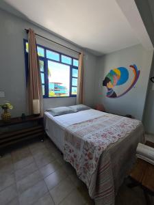 a bedroom with a bed and a large window at Soul Hostel Natal in Natal