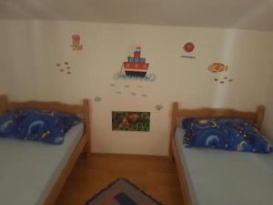 1 dormitorio con 2 camas y pared con pegatinas en Apartment in Slatine with sea view, terrace, air conditioning, WiFi 5147-1 en Slatine