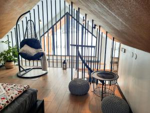 a living room with a spiral staircase in a house at Zawobaja in Zawoja