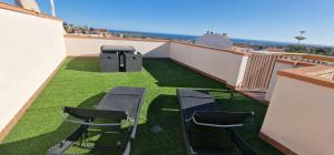a balcony with two chairs and a table and a grill at Casa Roda de Bará & Spa in Roda de Bará +13 photos