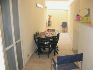 a dining room with a table and chairs at Glicine Apartment in Gallipoli