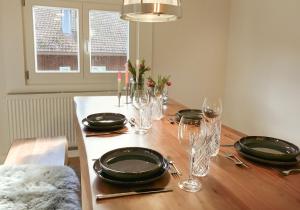 a dining room table with plates and glasses on it at Villa Roc in Grünenbach