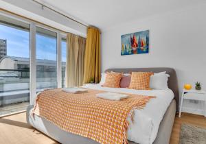 a bedroom with a bed and a large window at Golden Sunset House with free parking by My Getaways in Brighton & Hove