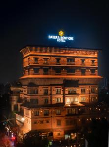 a building with a sign on top of it at night at Basera Boutique Hotel in Kathmandu