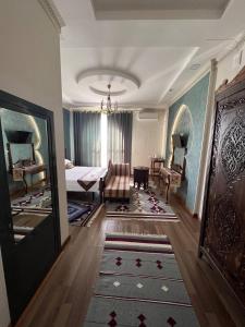 a bedroom with a bed and a living room at Jannat Minor Boutique Hotel in Urganch