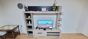 a tv sitting on a wooden stand in a room at Apartman Progresso in Valjevo