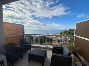 a balcony with chairs and a view of the ocean at Studio vue Mer in Carry-le-Rouet