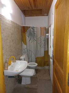 a bathroom with a toilet and a sink at l'univers, vous et nous in Pouilly-sur-Vingeanne