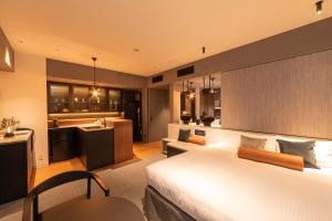 a hotel room with a bed and a kitchen at Hotel Keihan Namba Grande in Osaka