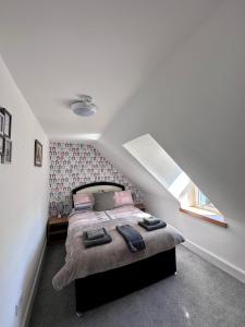 a bedroom with a large bed in a attic at Islay Frigate Hotel in Tarbert