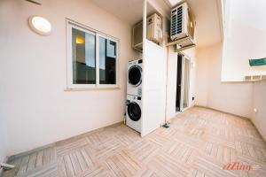 a laundry room with a washer and dryer in it at Modern Apartments in Malta's charming Mosta in Mosta