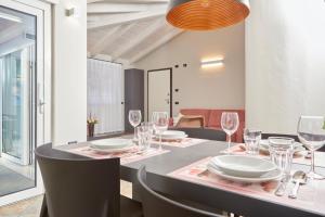 a dining room with a table with wine glasses at Residenza Ai Ferrari in Riva del Garda