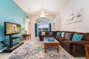 a living room with a couch and a tv at 16150EGRET- Sun Chaser (S) in Orlando