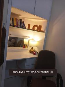 a desk with a lamp and a chair in a room at ED House in Fortaleza