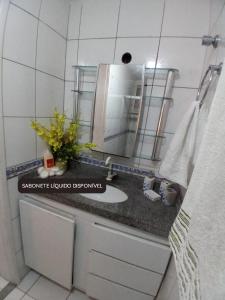 a bathroom with a sink and a mirror at ED House in Fortaleza