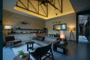a living room with a couch and a table at K House Phan Thiet by Blue Fingers in Ấp Bình Hưng