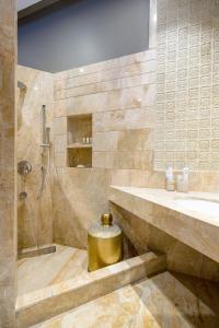 a bathroom with a shower and a sink and a toilet at amã Stays & Trails Kailash House in Kodaikānāl