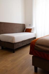 a bed sitting in a room next to a window at Michelangelo Vatican Rooms in Rome