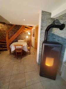 a room with a fireplace in the middle of a room at Aux balcons de la vallée in Soultzeren