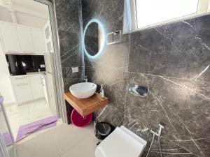 a bathroom with a sink and a mirror at Villa Denis Ksamil in Ksamil