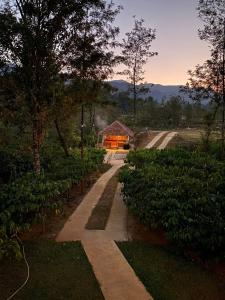 a garden with a greenhouse in the middle of a field at FernHills Homestay in Madikeri