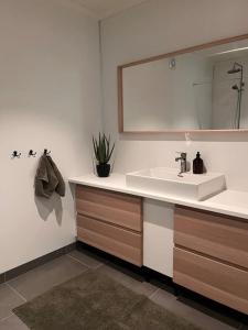 a bathroom with a sink and a mirror at Cozy house in Eidfjord in Eidfjord