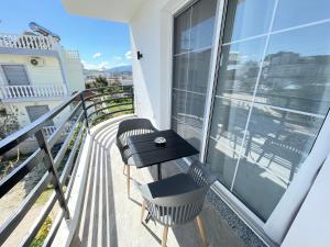 a balcony with two chairs and a table at Villa Denis Ksamil in Ksamil